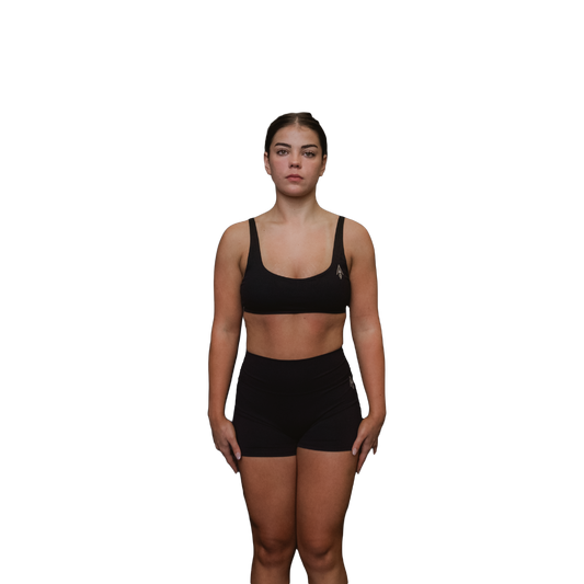 Woman wearing a black sports bra front view