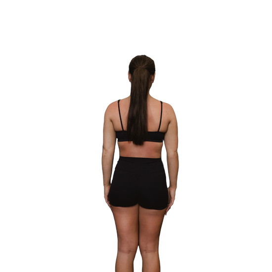 Woman wearing a black sports bra rear view 