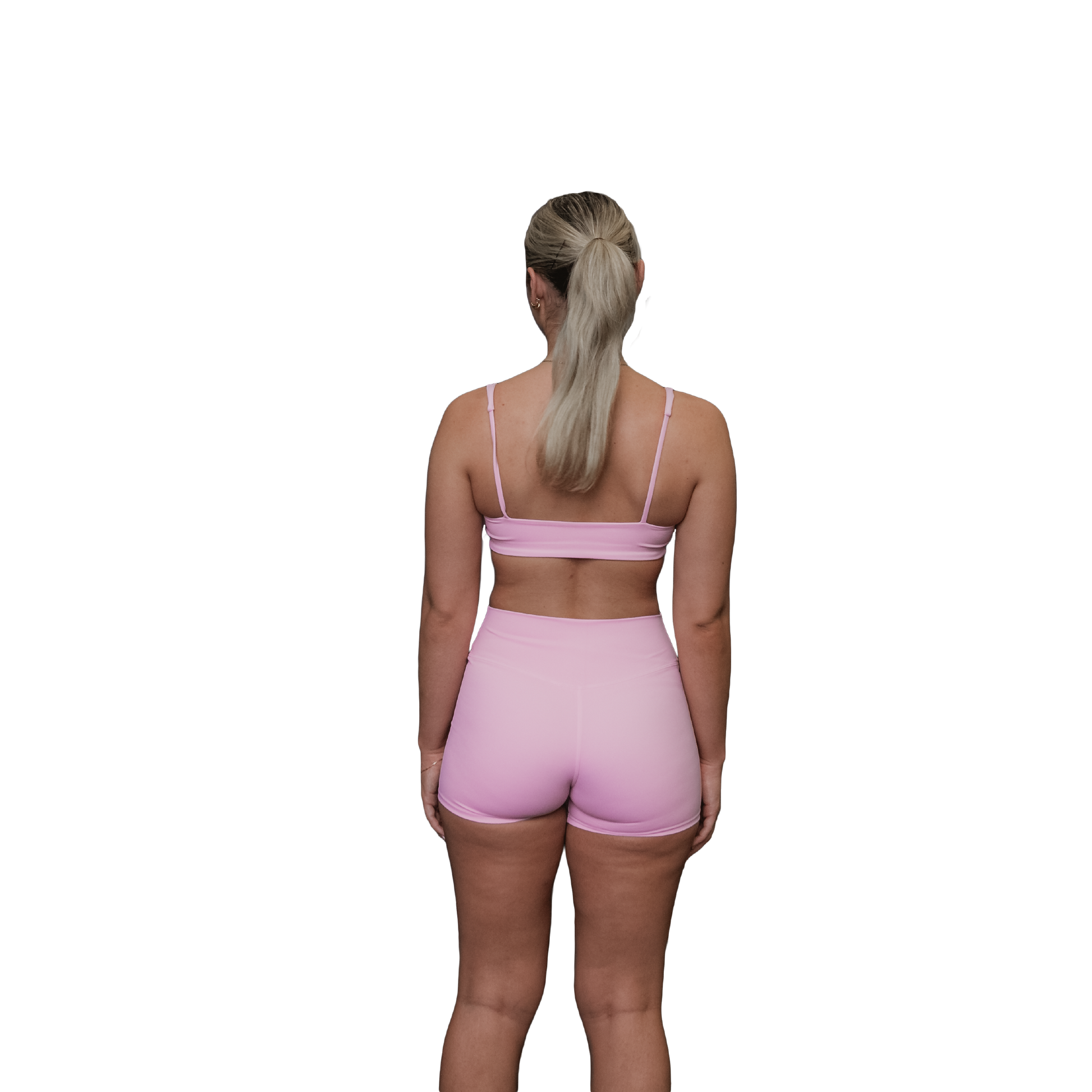 Woman wearing a pink sports bra rear view